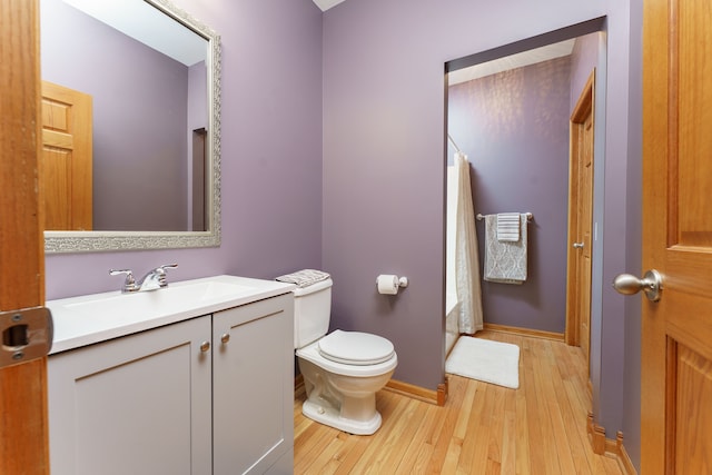 bathroom with vanity, wood-type flooring, and toilet