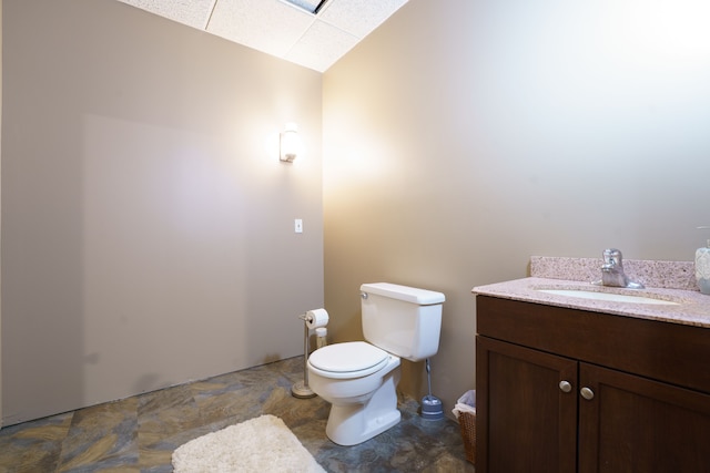 bathroom featuring vanity, toilet, and vaulted ceiling