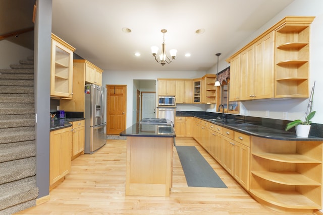 kitchen with light brown cabinets, stainless steel appliances, and a kitchen island