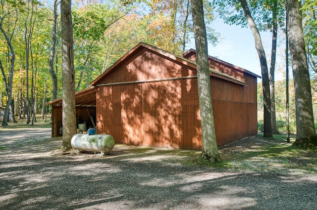 view of side of home featuring an outbuilding