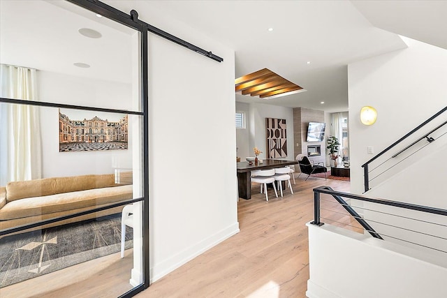 interior space featuring a barn door and light hardwood / wood-style flooring