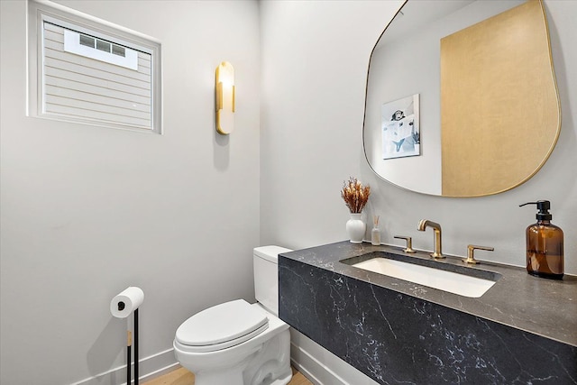 bathroom featuring toilet and sink