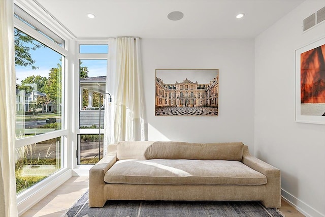 living area with wood-type flooring and plenty of natural light