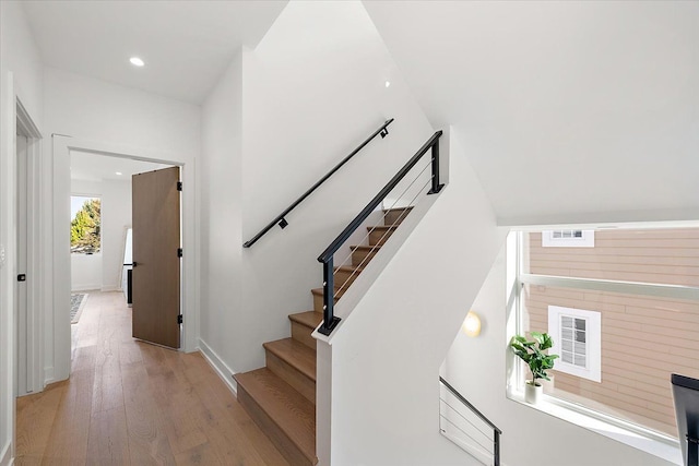 stairway with hardwood / wood-style floors