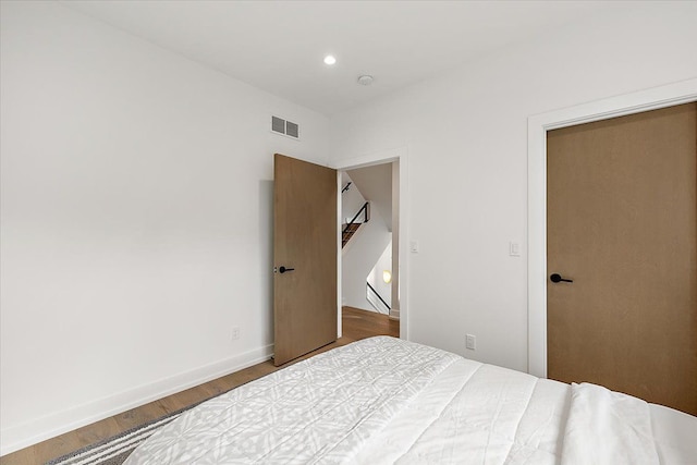 bedroom with wood-type flooring