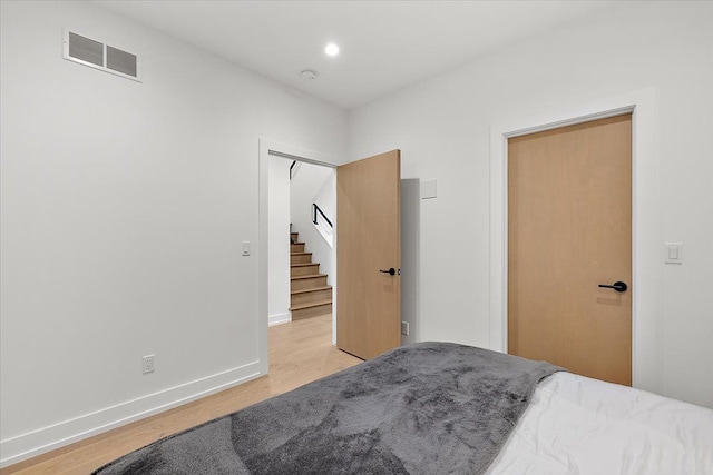 bedroom featuring light hardwood / wood-style flooring and a closet