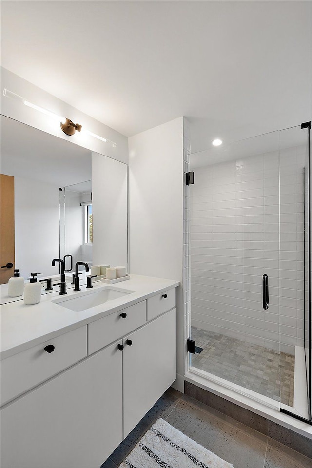 bathroom with vanity and an enclosed shower