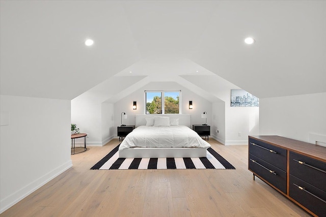 bedroom featuring light hardwood / wood-style floors and lofted ceiling