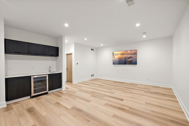 bar featuring light hardwood / wood-style flooring, wine cooler, and sink