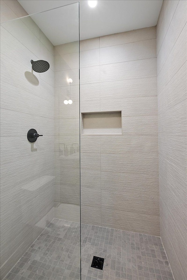 bathroom with tiled shower