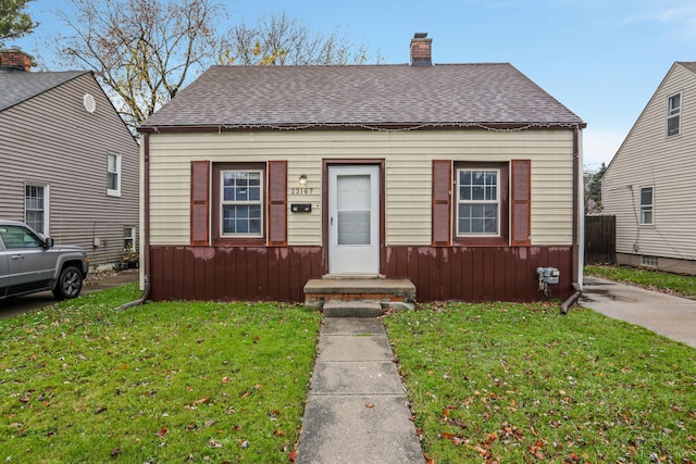 bungalow-style house with a front lawn