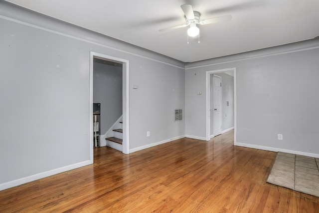 spare room with ceiling fan and wood-type flooring