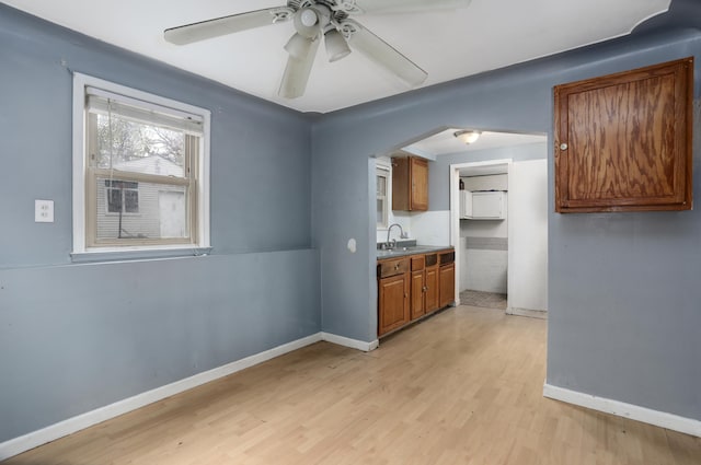 22167 Rausch Ave, Eastpointe, MI 48021 - unfurnished dining area featuring baseboards, ceiling fan, a sink, and light wood finished floors