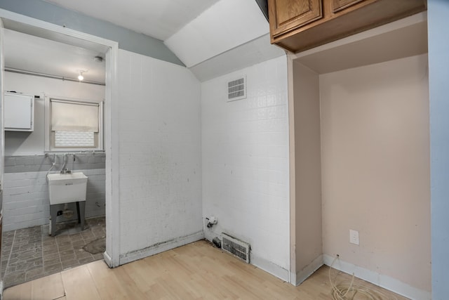 22167 Rausch Ave, Eastpointe, MI 48021 - laundry area featuring light wood-type flooring and a wood stove