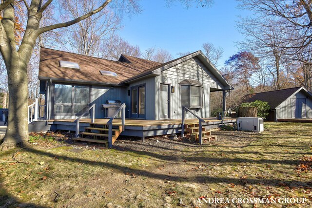 1155 Edgewater Ter, South Haven, MI 49090 - view of front facade featuring a deck, roof with shingles, and a front yard