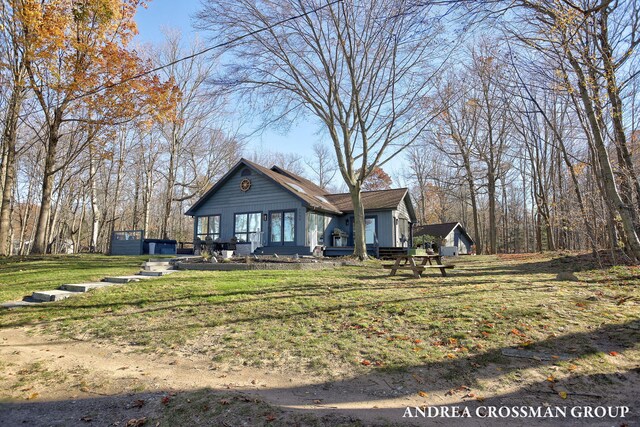 1155 Edgewater Ter, South Haven, MI 49090 - view of front facade with board and batten siding and a front yard