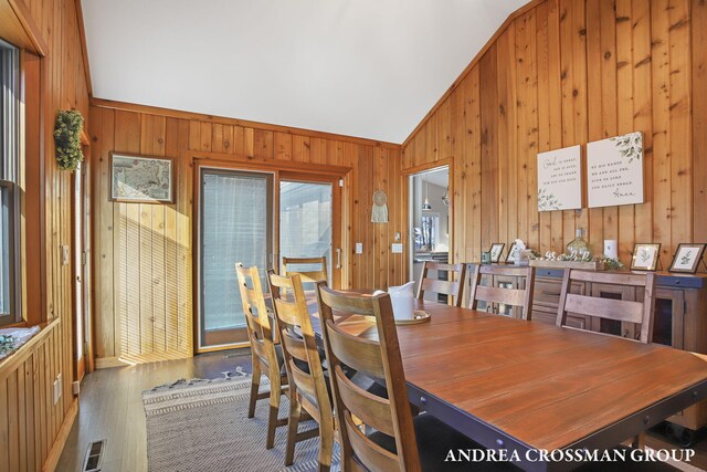 1155 Edgewater Ter, South Haven, MI 49090 - dining area with wooden walls, vaulted ceiling, and wood finished floors