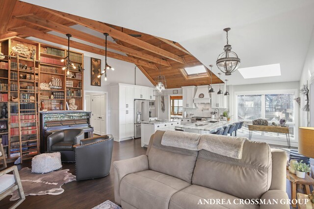 1155 Edgewater Ter, South Haven, MI 49090 - living room with a skylight, dark wood-style flooring, beamed ceiling, a chandelier, and high vaulted ceiling