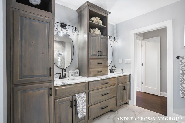 1155 Edgewater Ter, South Haven, MI 49090 - bathroom with double vanity, marble look tiles, and baseboards
