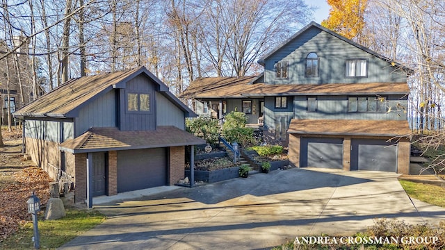 1155 Edgewater Ter, South Haven, MI 49090 - view of front of home with driveway, an attached garage, and brick siding
