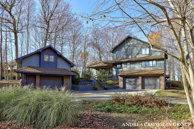 1155 Edgewater Ter, South Haven, MI 49090 - view of property exterior featuring an attached garage, concrete driveway, and brick siding