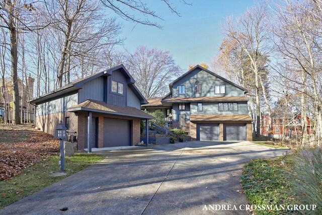 1155 Edgewater Ter, South Haven, MI 49090 - view of front of property with concrete driveway, a garage, and brick siding