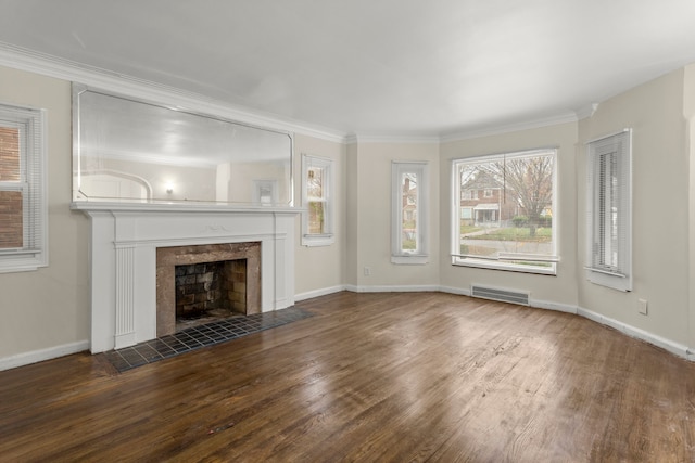 unfurnished living room featuring ornamental molding, dark wood-type flooring, and a tile fireplace