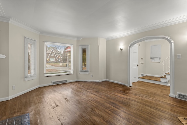 spare room featuring dark hardwood / wood-style floors and crown molding