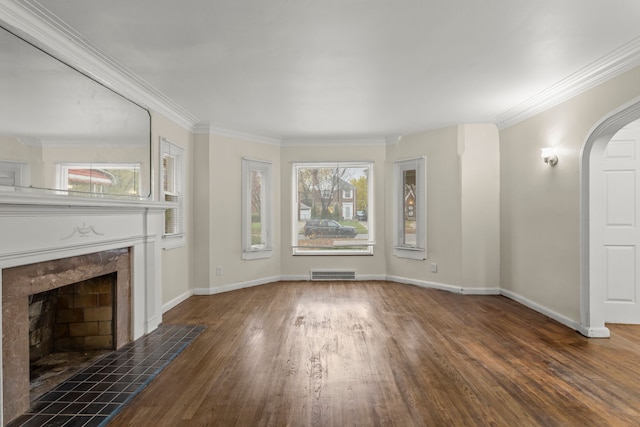 unfurnished living room with a fireplace, crown molding, and dark wood-type flooring