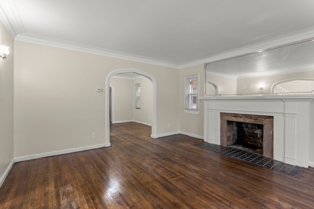 unfurnished living room featuring a fireplace, dark hardwood / wood-style flooring, and crown molding