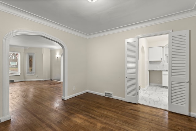 unfurnished room featuring dark hardwood / wood-style flooring and ornamental molding