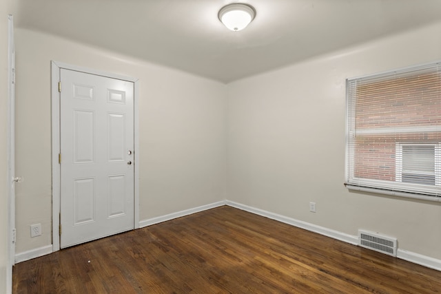 unfurnished room with dark hardwood / wood-style floors