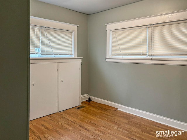 unfurnished bedroom featuring a closet and light hardwood / wood-style flooring