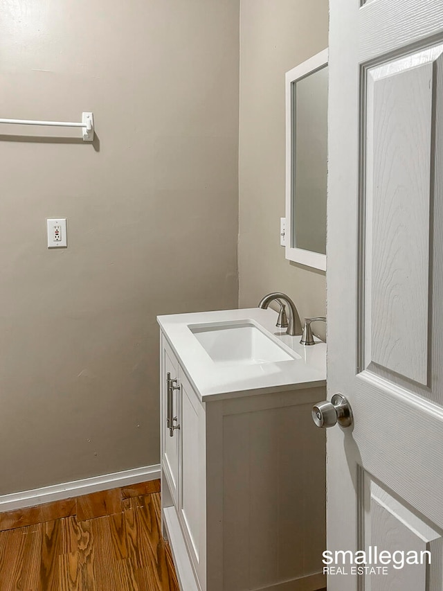 bathroom with hardwood / wood-style flooring and vanity