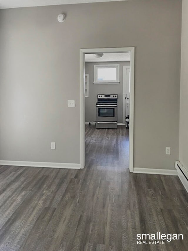 hall with dark hardwood / wood-style flooring and a baseboard heating unit