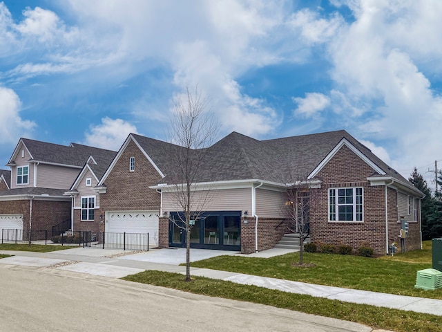 view of front of house with a front yard and a garage