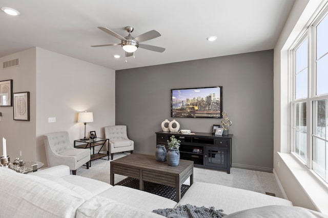 carpeted living room featuring plenty of natural light and ceiling fan