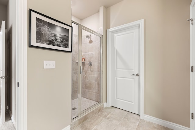 bathroom featuring tile patterned floors and a shower with door