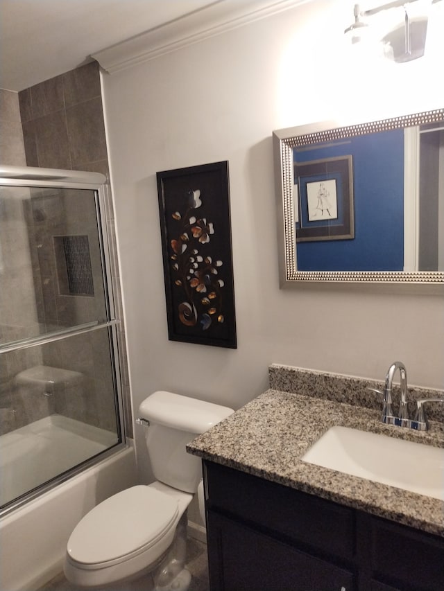 full bathroom with shower / bath combination with glass door, vanity, toilet, and ornamental molding