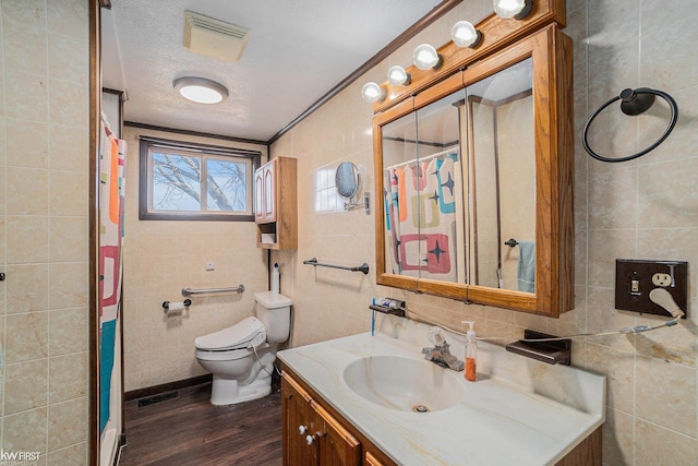470 Michelson Rd, Houghton Lake, MI 48629 - bathroom featuring tile walls, wood finished floors, vanity, a shower with shower curtain, and toilet