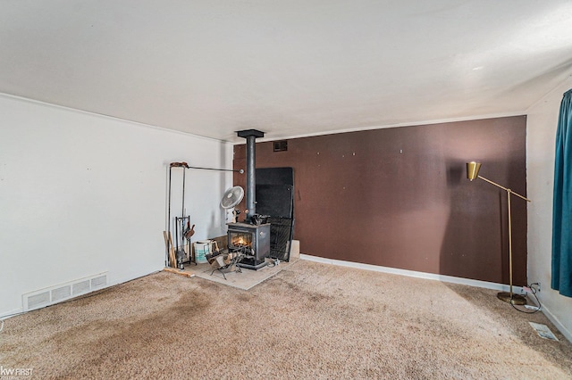 470 Michelson Rd, Houghton Lake, MI 48629 - carpeted living room featuring a wood stove
