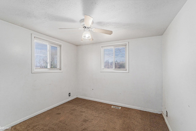 470 Michelson Rd, Houghton Lake, MI 48629 - spare room with healthy amount of natural light, carpet flooring, baseboards, ceiling fan, and a textured ceiling