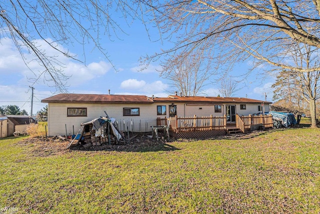 470 Michelson Rd, Houghton Lake, MI 48629 - rear view of house featuring a deck, a yard, and a storage shed