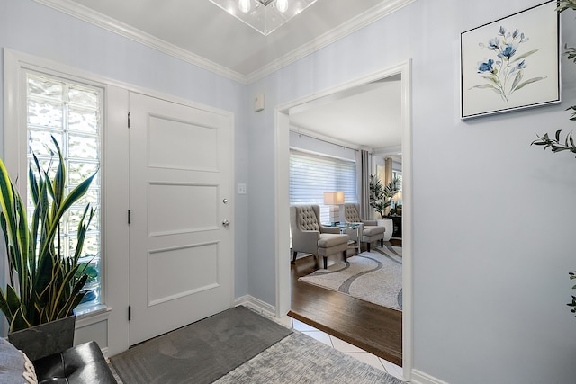 foyer with wood-type flooring and ornamental molding