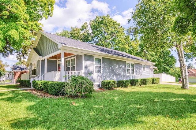 view of home's exterior with covered porch and a yard