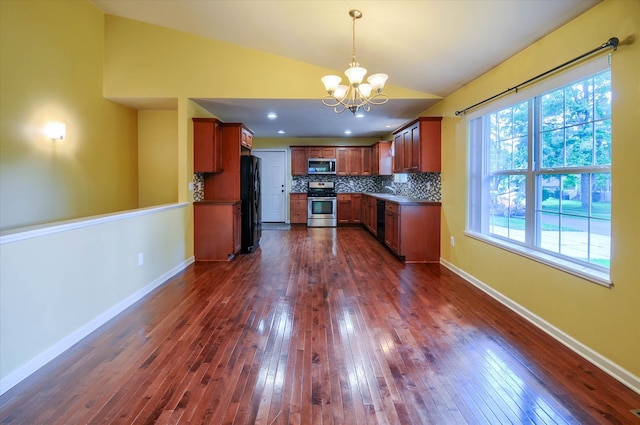 kitchen featuring black appliances, a notable chandelier, dark wood-type flooring, and vaulted ceiling