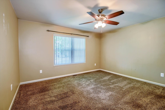 spare room with ceiling fan and carpet