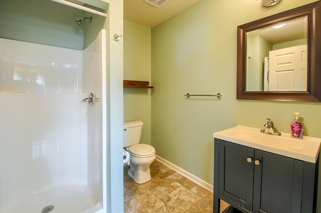 bathroom featuring a shower, vanity, and toilet