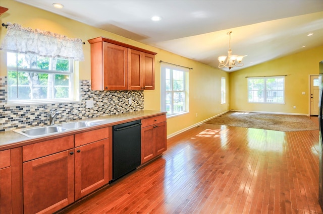 kitchen featuring a wealth of natural light, dishwasher, a chandelier, and sink