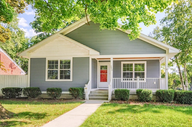 bungalow with a front yard and a porch